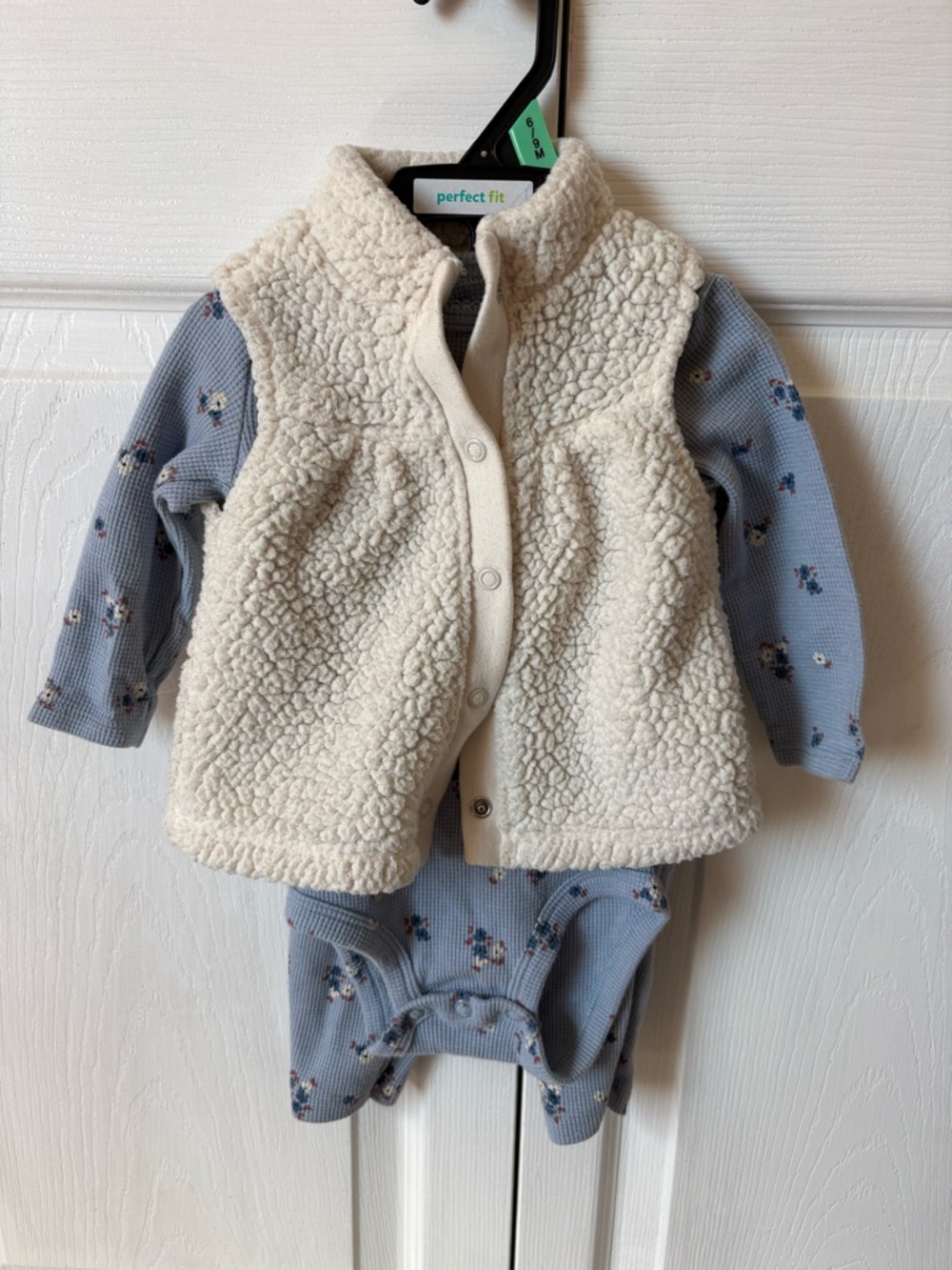 Carter's Cream Sherpa Vest Over Blue Floral Bodysuit